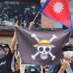 Asian youths fly ‘One Piece’ flag in protest